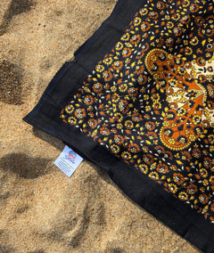 Detail of the Desert Sand giant cotton beach mat's hand-dyed texture and fringe