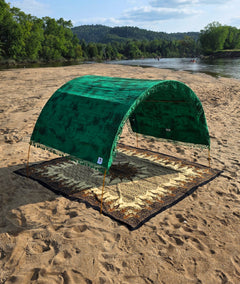 Rainforest Green tie-dye Suniela shade cabana styled with the Desert Sand giant cotton beach mat