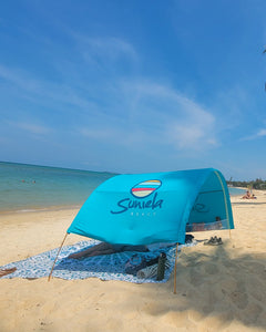 Side view of Turquoise Suniela Travel-Ready shade cabana on beach