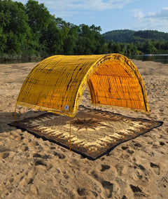 Close-up of the yellow tie-dye hand-dyed cotton pattern on the Suniela shade cabana